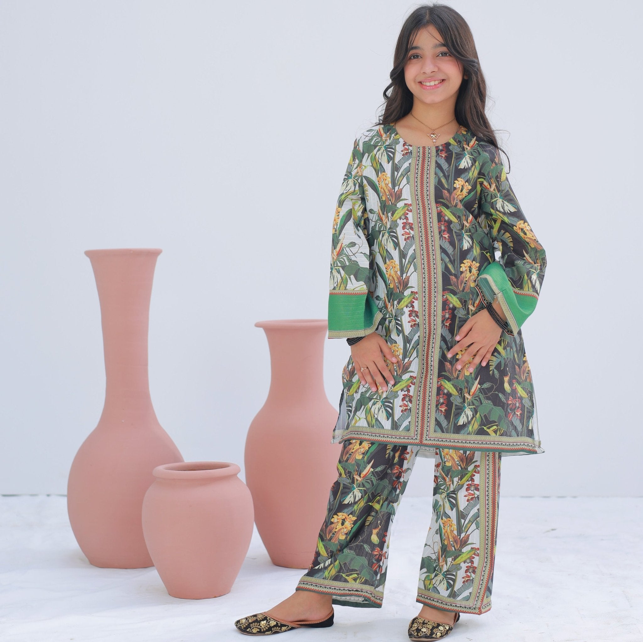 Girl wearing Zardham White & Sage embroidered kurta with sage green trousers, front view