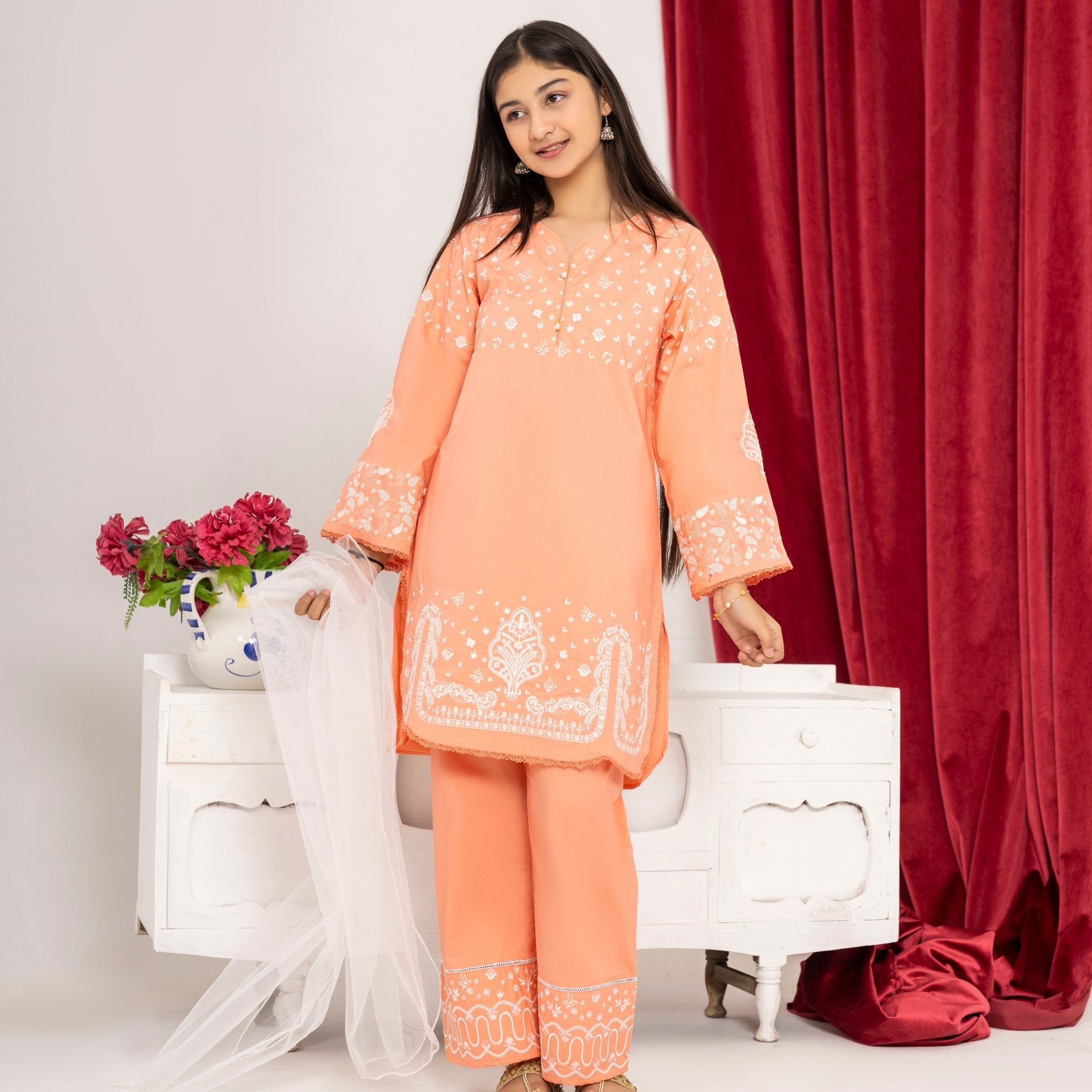 Girl wearing Zardham Blush Coral embroidered kurta and trouser set, full front view