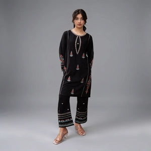 MEHRAAB - Zardham – Trendy Clothing for Girls & WomenGirls' ClothingA girl modeling a black embroidered kurta and matching wide-leg pants set against a neutral gray studio background.