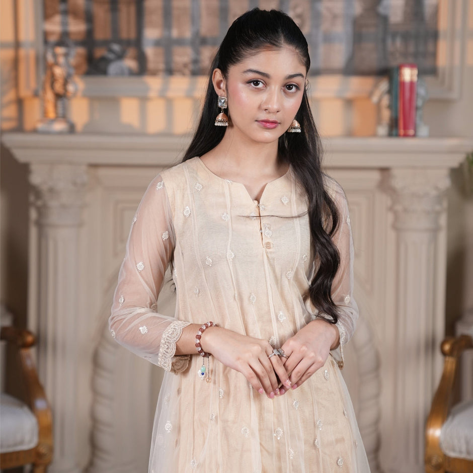 Model wearing Zardham – Trendy Clothing for Girls & Women ivory net maxi with delicate floral embroidery and lace hem.