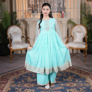 Young girl wearing a Zardham – Trendy Clothing for Girls & Women mint net frock with gold embroidery and raw silk sharara
