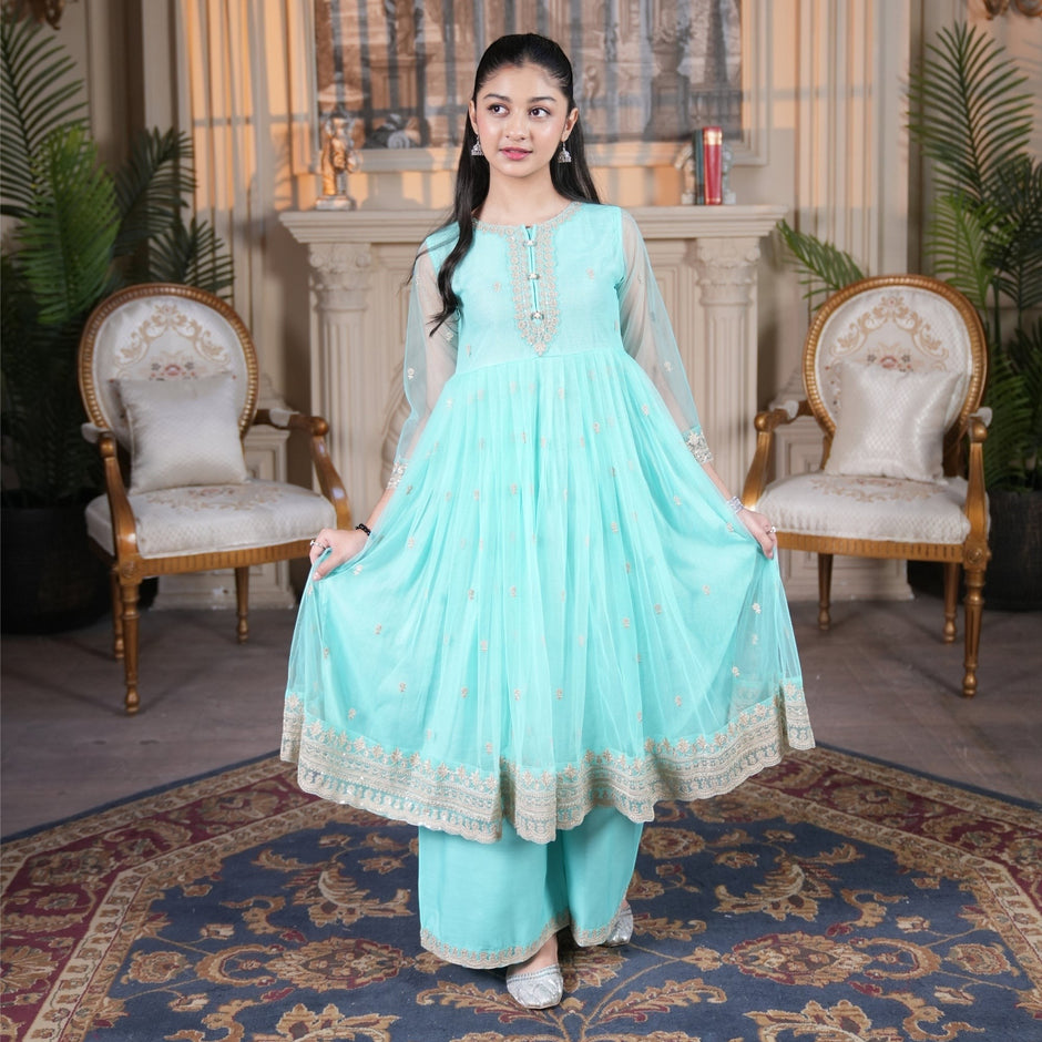 Young girl wearing a Zardham – Trendy Clothing for Girls & Women mint net frock with gold embroidery and raw silk sharara