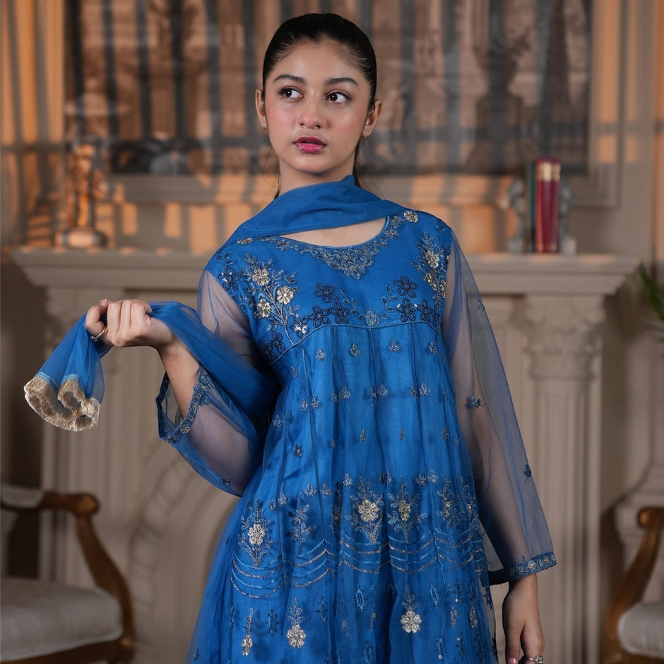 Model wearing Zardham – Trendy Clothing for Girls & Women royal blue net Anarkali with gold and silver floral embroidery