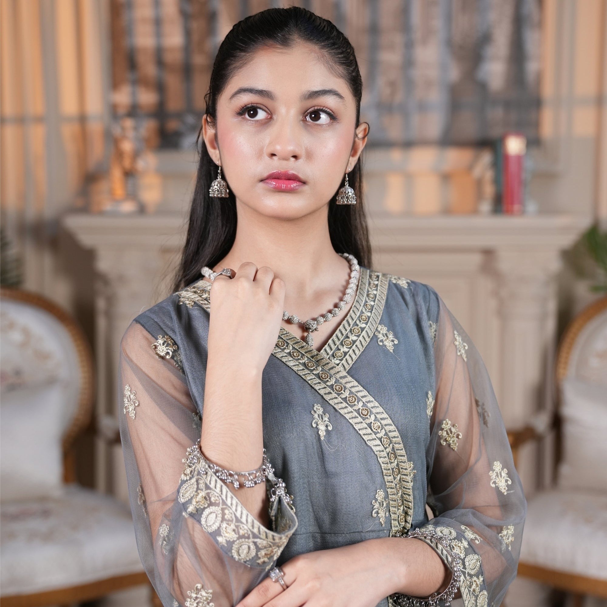Zardham – Trendy Clothing for Girls & Women slate grey raw silk Angrakha suit with gold embroidery and net sleeves.